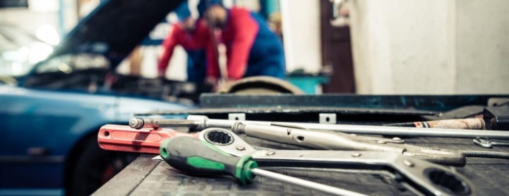 Service technicians working on an engine. Close-up of work tools.